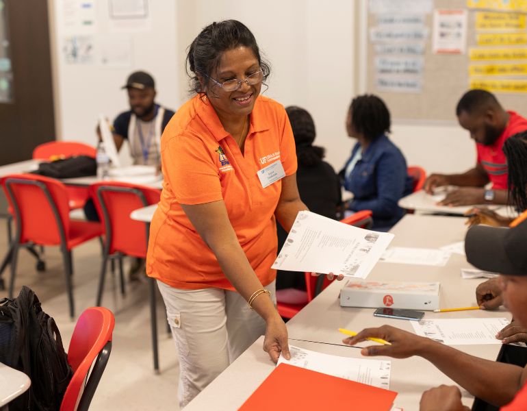 031174.JPG Palm Beach County Extension agent Joyce Sookram handing out information to course participants. Photo taken 10-03-23