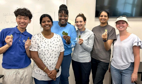 students in the classroom posing for the camera after successfully completing a project