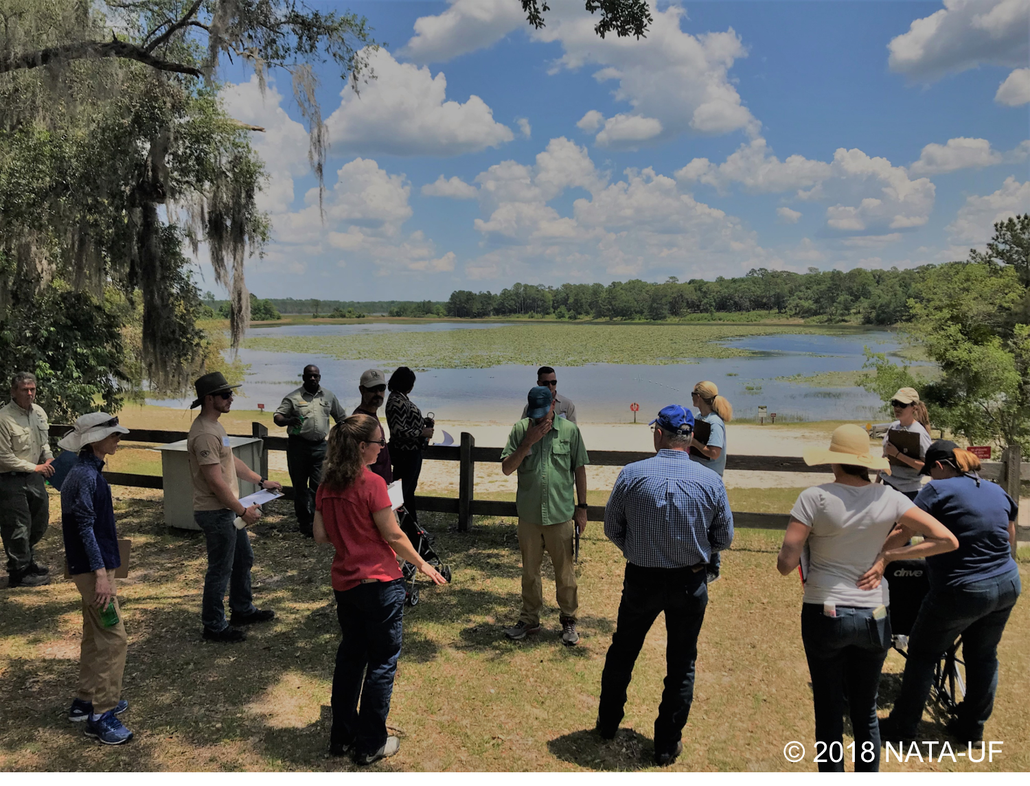 Students gathering around a lake.